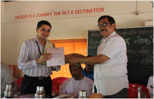 RMCET principal Dr. M. M. Bhagwat receiving letter of appreciation